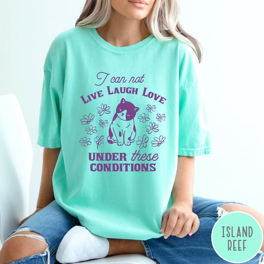 Comfort Colors tee in Island Reef featuring whimsical graphic style with a cat and flowers and text.