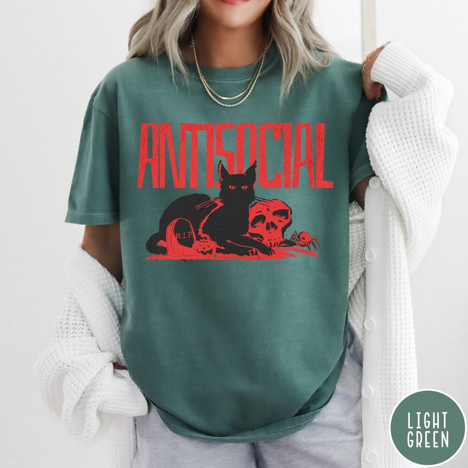 Comfort Colors tee in Light Green featuring retro graphic design of a black cat with skull and tombstone