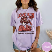 Comfort Colors tee in Orchid featuring retro style graphic of a woman wearing a gas mask
