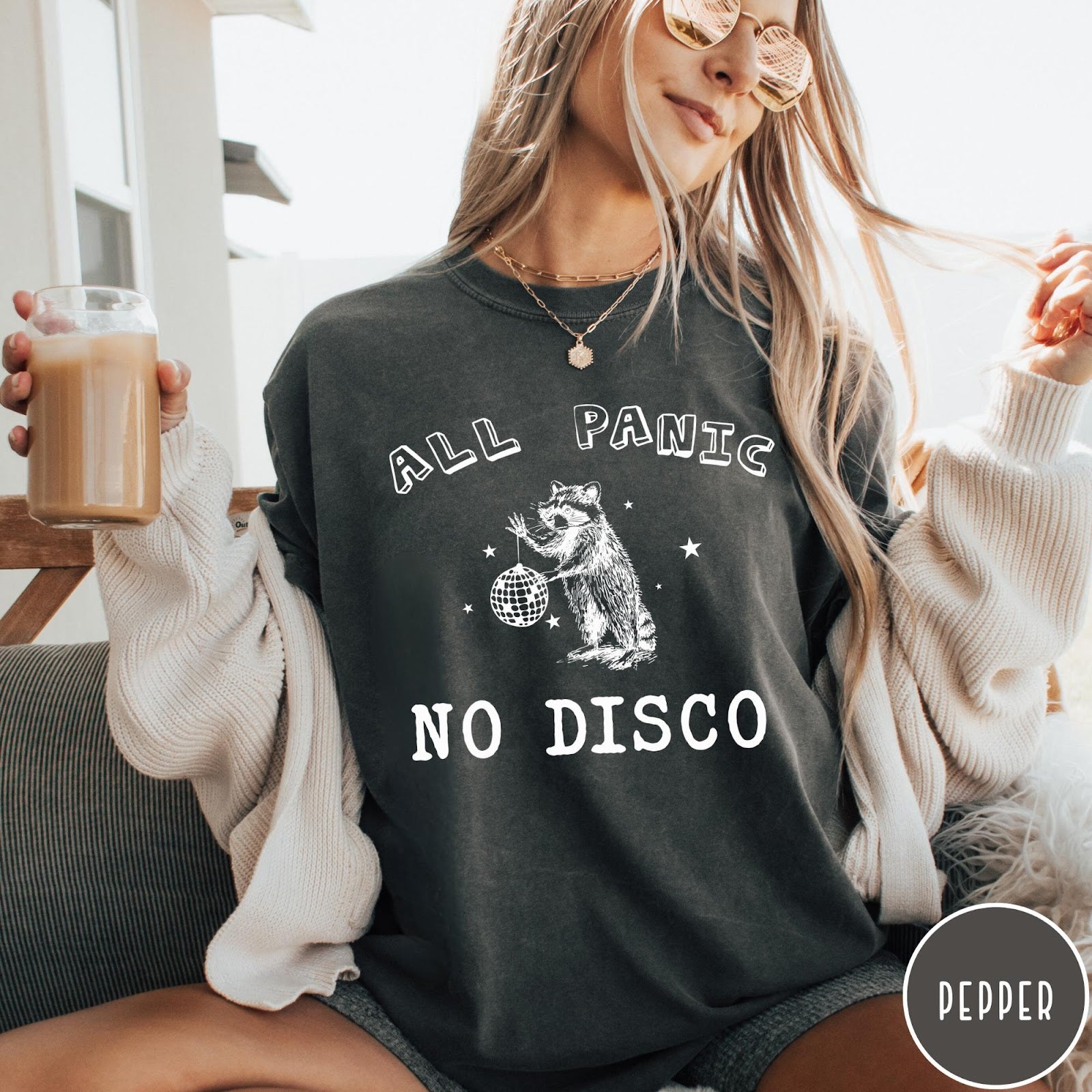 Comfort Colors tee in Pepper featuring screen printed raccoon graphic holding a disco ball with star accents