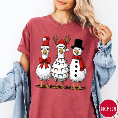 Comfort Colors tee in Crimson featuring festive holiday graphic of three geese dressed as Santa and snowman