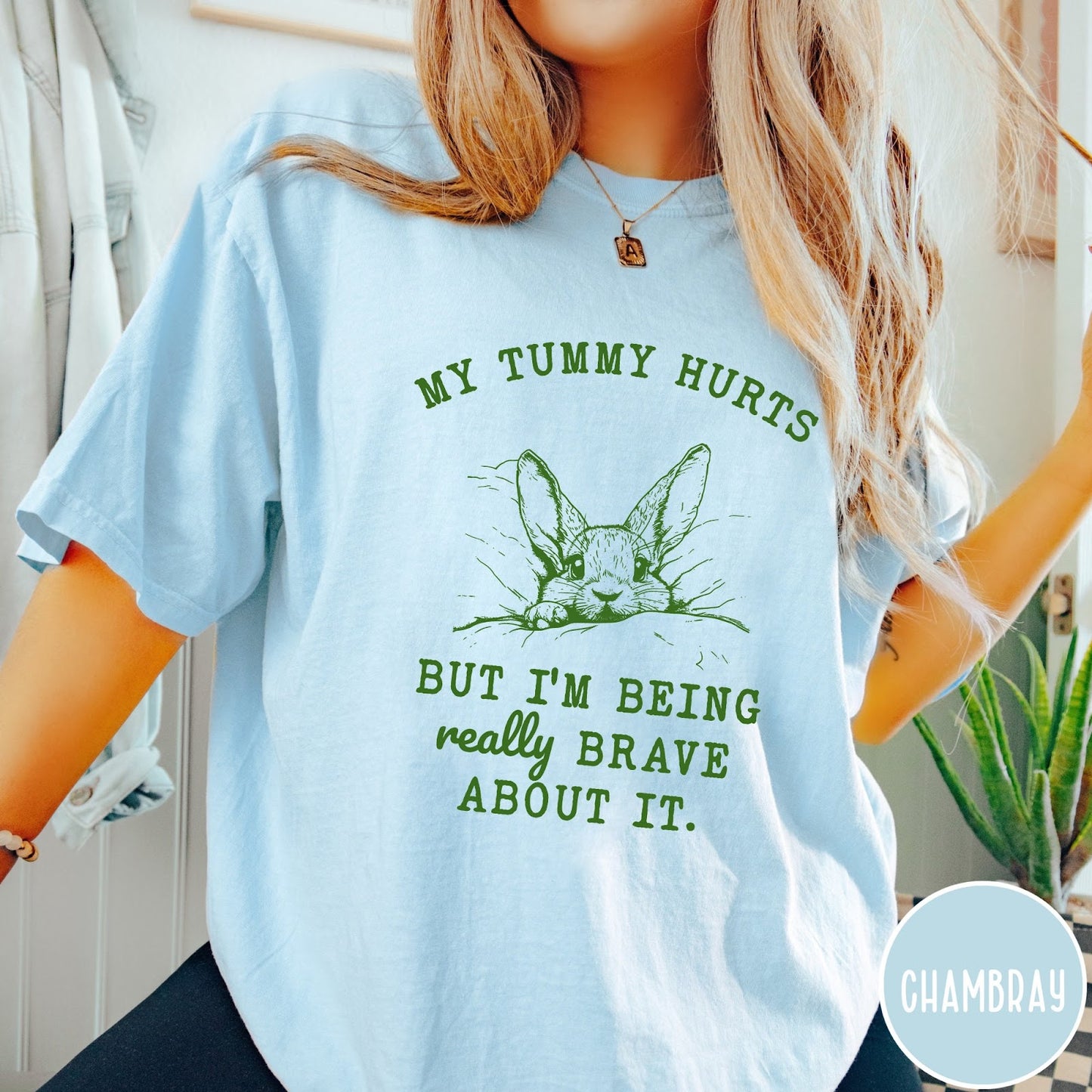 Comfort Colors tee in Chambray featuring line art graphic of a bunny with text My Tummy Hurts