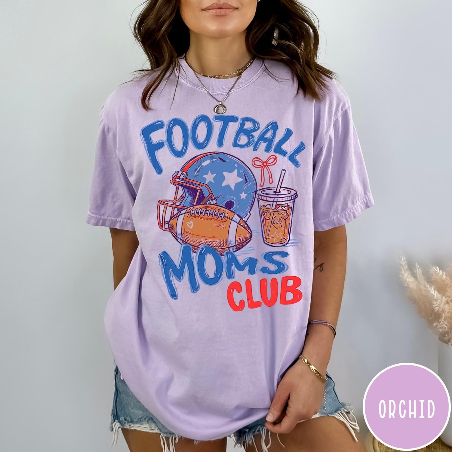 Comfort Colors tee in Orchid featuring football mom lifestyle graphic with helmet, football, and iced coffee