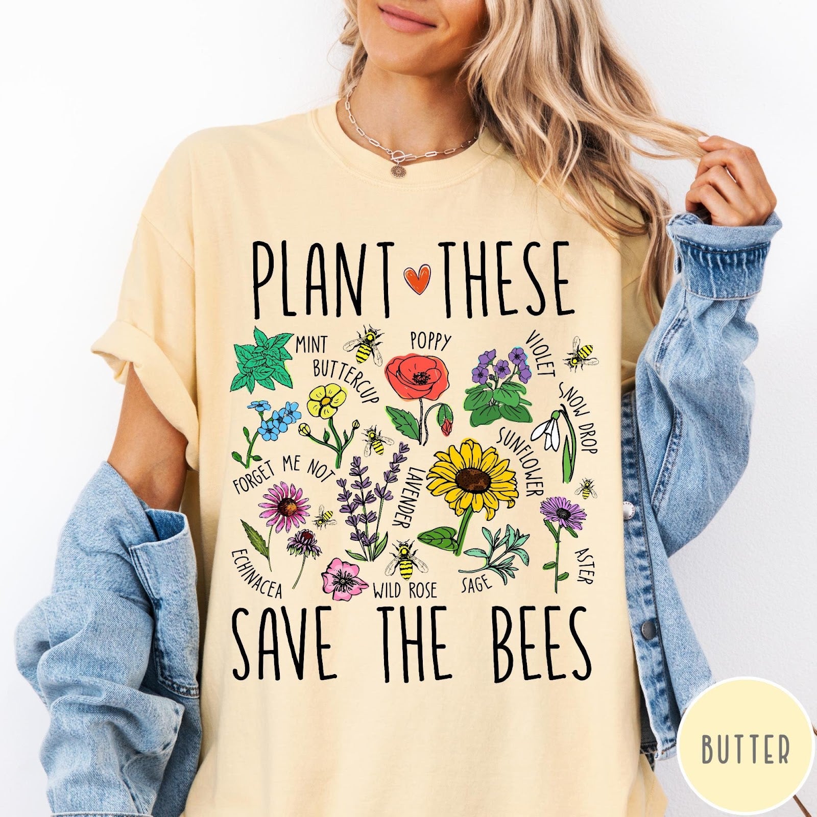 Comfort Colors tee in Butter featuring botanical garden style graphic with various flowers and bees