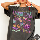 Comfort Colors tee in Pepper featuring vintage style Mardi Gras icons including a saxophone, mask, and umbrella.