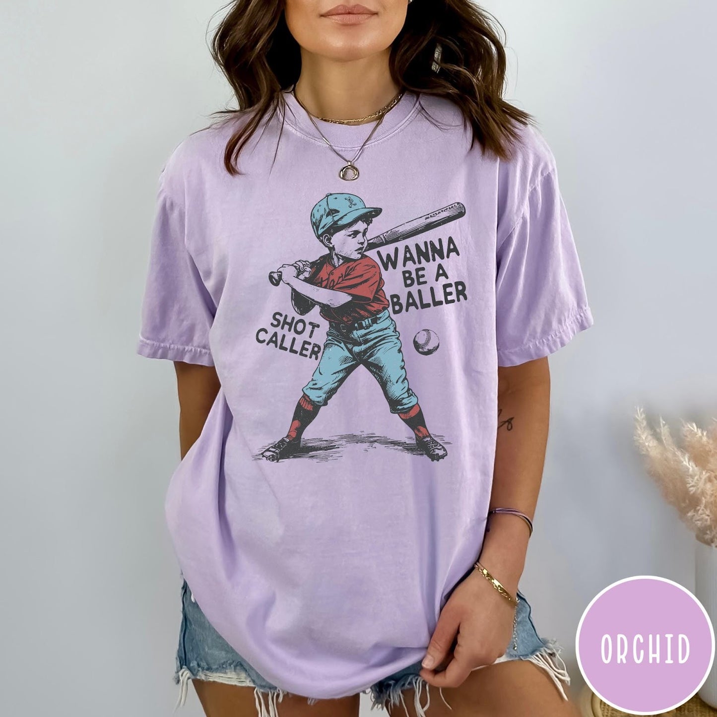 Comfort Colors tee in Orchid featuring vintage style baseball player graphic with Wanna Be a Baller text