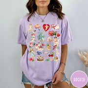 Comfort Colors tee in Orchid featuring vintage Valentine collage graphic with cherubs, flowers, cats, and romantic symbols