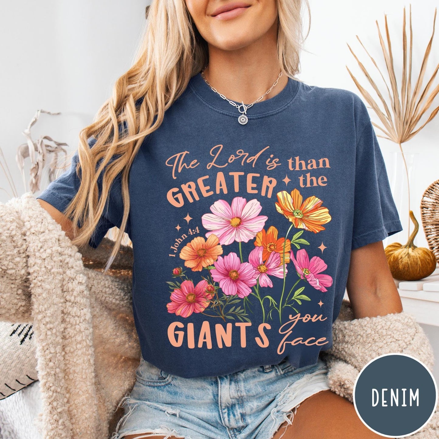 Comfort Colors tee in Denim featuring floral Bible verse graphic design with 1 John 4:4 scripture text
