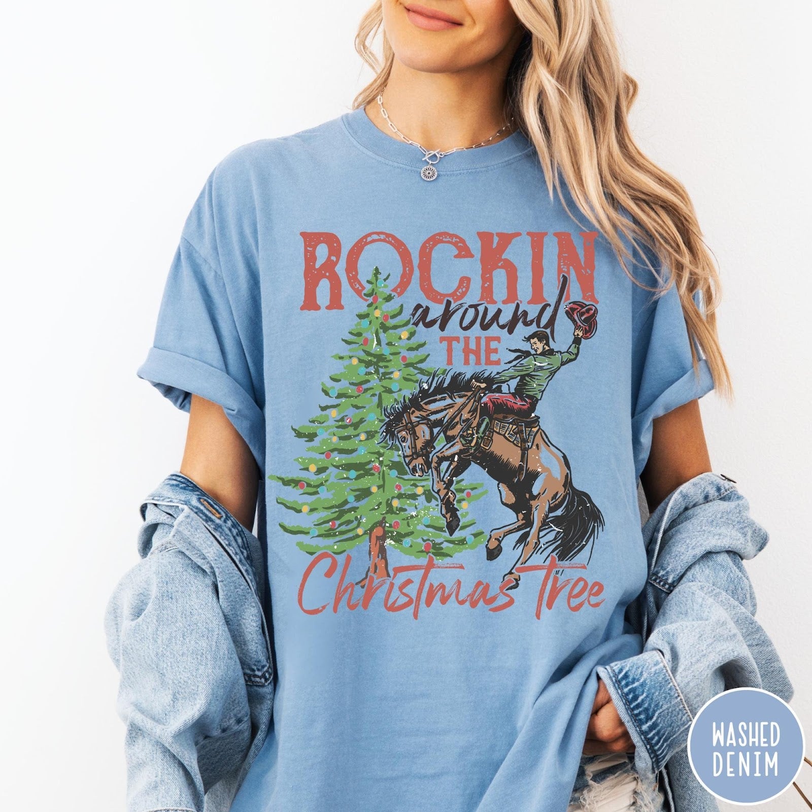 Comfort Colors tee in Washed Denim featuring western graphic design of a cowboy on a bucking horse Christmas tree