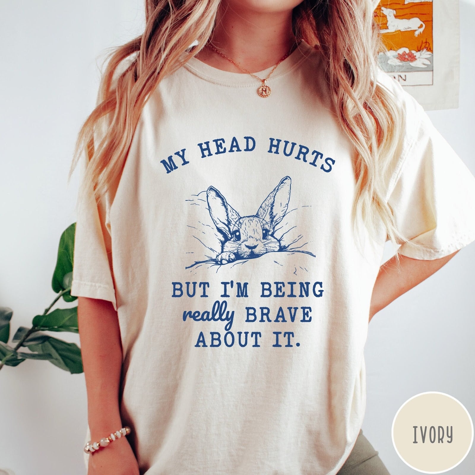 Comfort Colors tee in Ivory featuring line art graphic of a bunny resting its head on a pillow