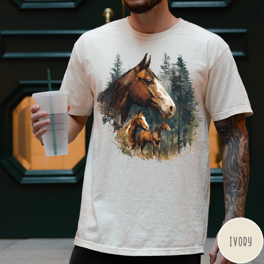 Comfort Colors tee in Ivory featuring vintage style graphic of three horses standing in a pine forest