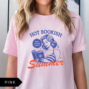 Comfort Colors tee in Pink featuring pinup girl reading a book graphic design with blue and orange ink