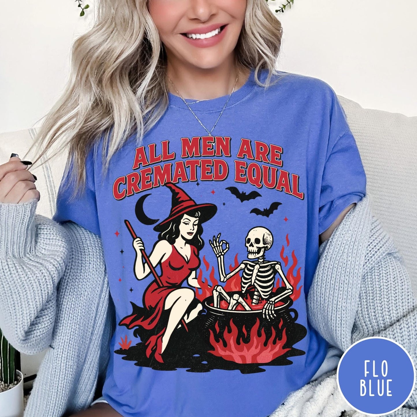 Comfort Colors tee in Flo Blue featuring witch and skeleton graphic with a boiling cauldron and spooky text
