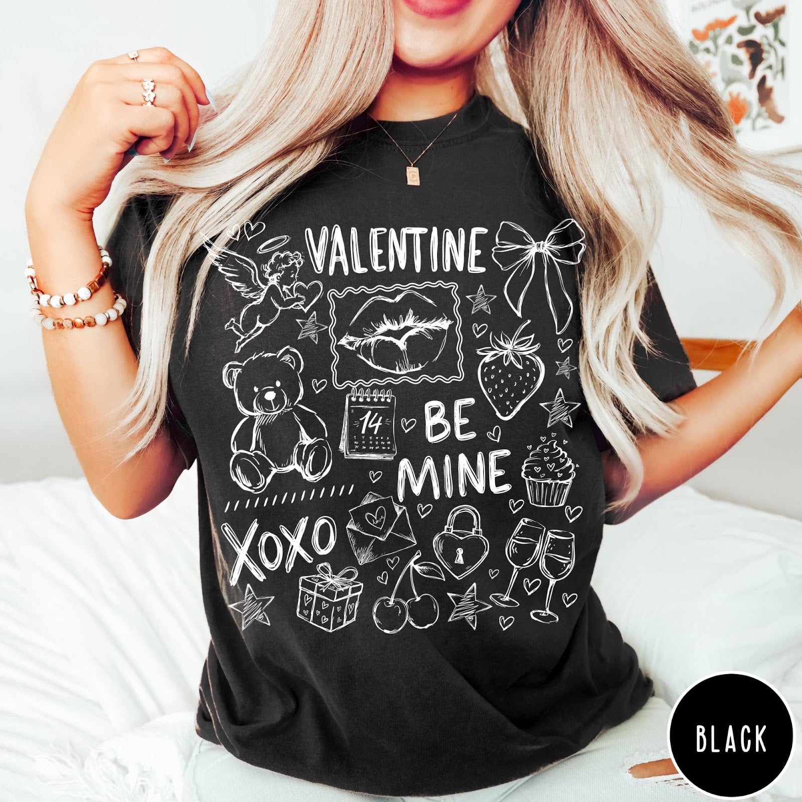 Comfort Colors tee in Black featuring Valentine's Day collage graphic with cupid, teddy bear, and romantic symbols