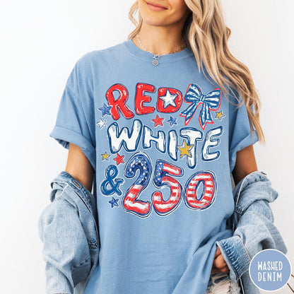 Comfort Colors tee in Denim featuring patriotic 250th anniversary graphic with red white and blue stars and bow