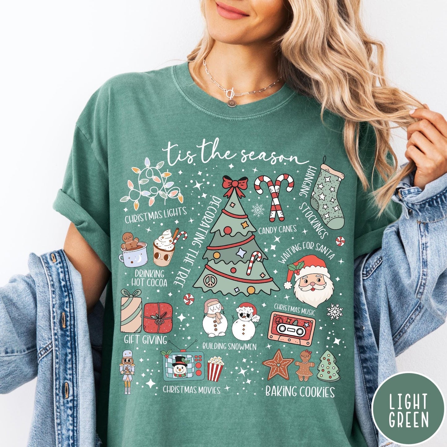 Comfort Colors tee in Light Green featuring festive holiday graphic with Christmas icons like a tree and cocoa