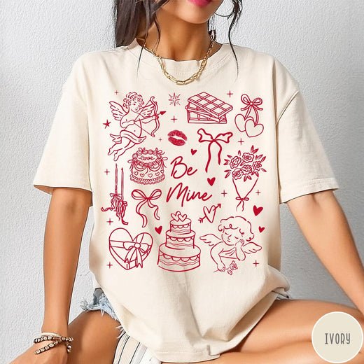 Comfort Colors tee in Ivory featuring Valentine's Day collage design with cupid, cake, flowers, and chocolate graphics