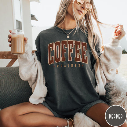 Comfort Colors tee in Pepper featuring collegiate style Coffee Weather graphic with distressed brown text and stars