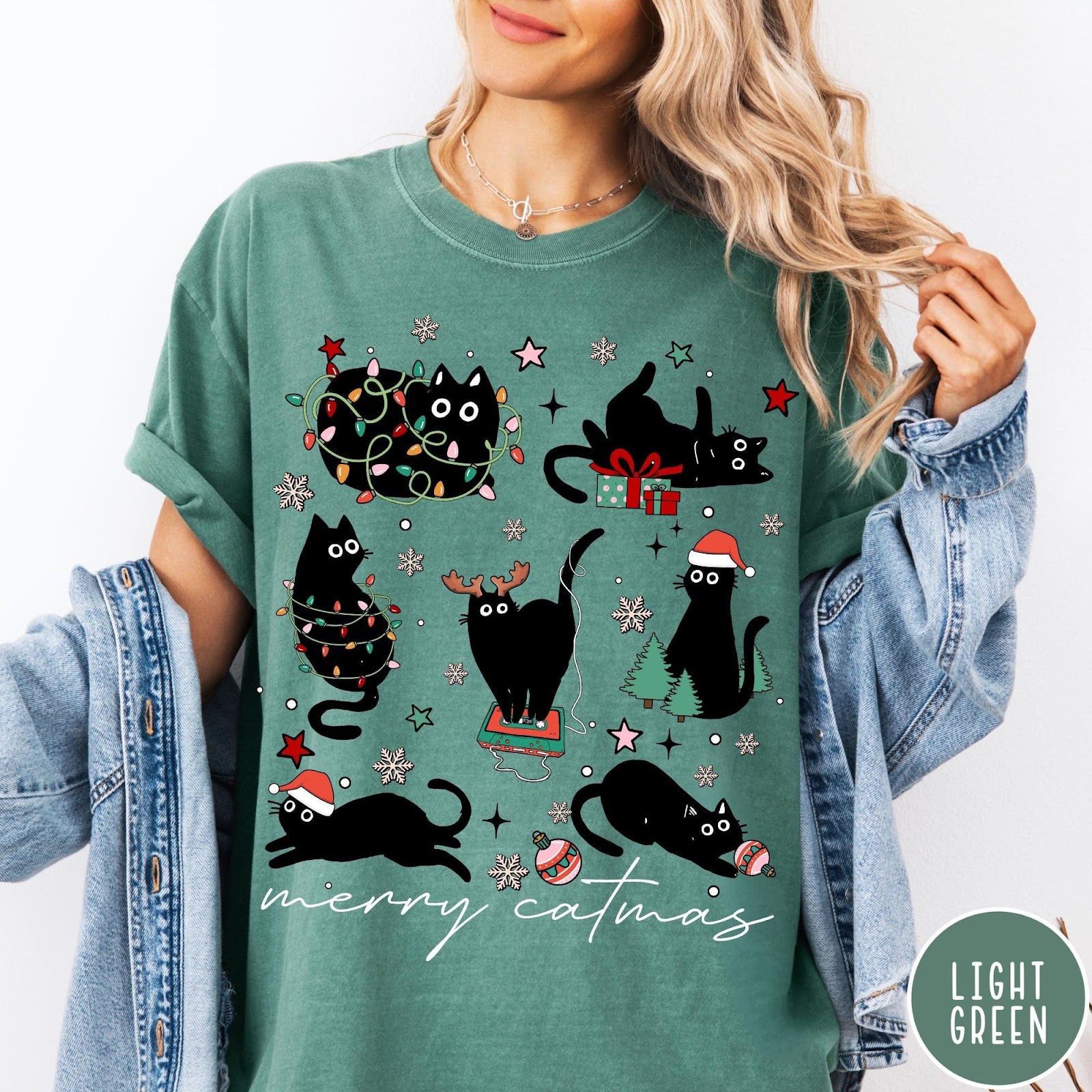 Comfort Colors tee in Light Green featuring festive holiday graphic with multiple black cats and Christmas elements