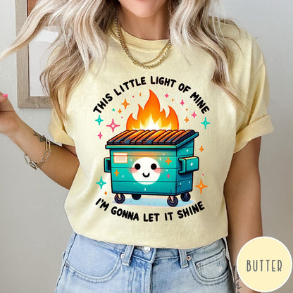 Comfort Colors tee in Butter featuring cartoon style graphic of a smiling dumpster fire with text