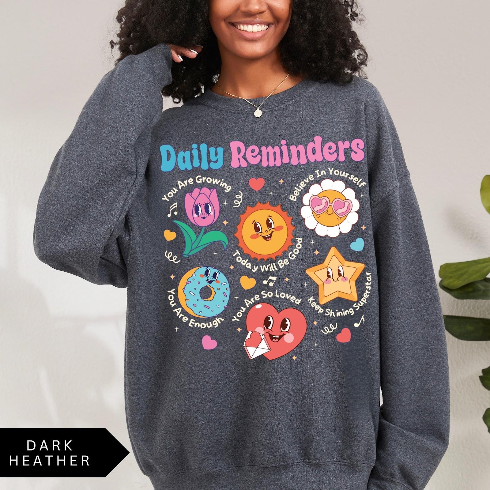 Comfort Colors tee in Dark Heather featuring retro mascot design with daily affirmations and colorful graphics