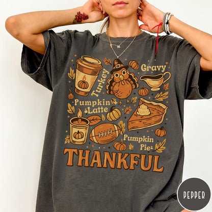 Comfort Colors tee in Pepper featuring retro Thanksgiving dinner items including turkey, pumpkin latte, and pumpkin pie graphic
