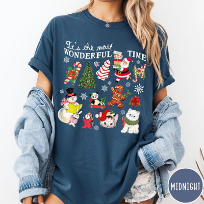 Comfort Colors tee in Midnight featuring Christmas collage graphic with Santa, snowman, animals, and holiday icons