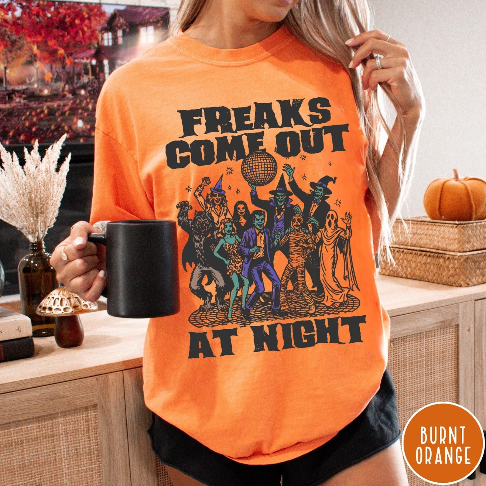 Comfort Colors tee in Burnt Orange featuring retro disco style graphic of dancing monsters and a disco ball