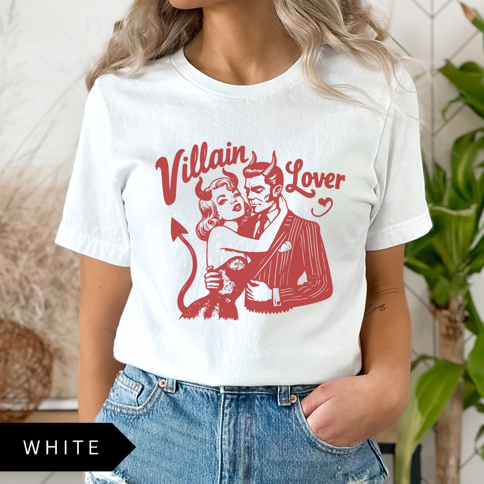 Comfort Colors tee in White featuring vintage style graphic of a devilish couple embracing with text Villain Lover