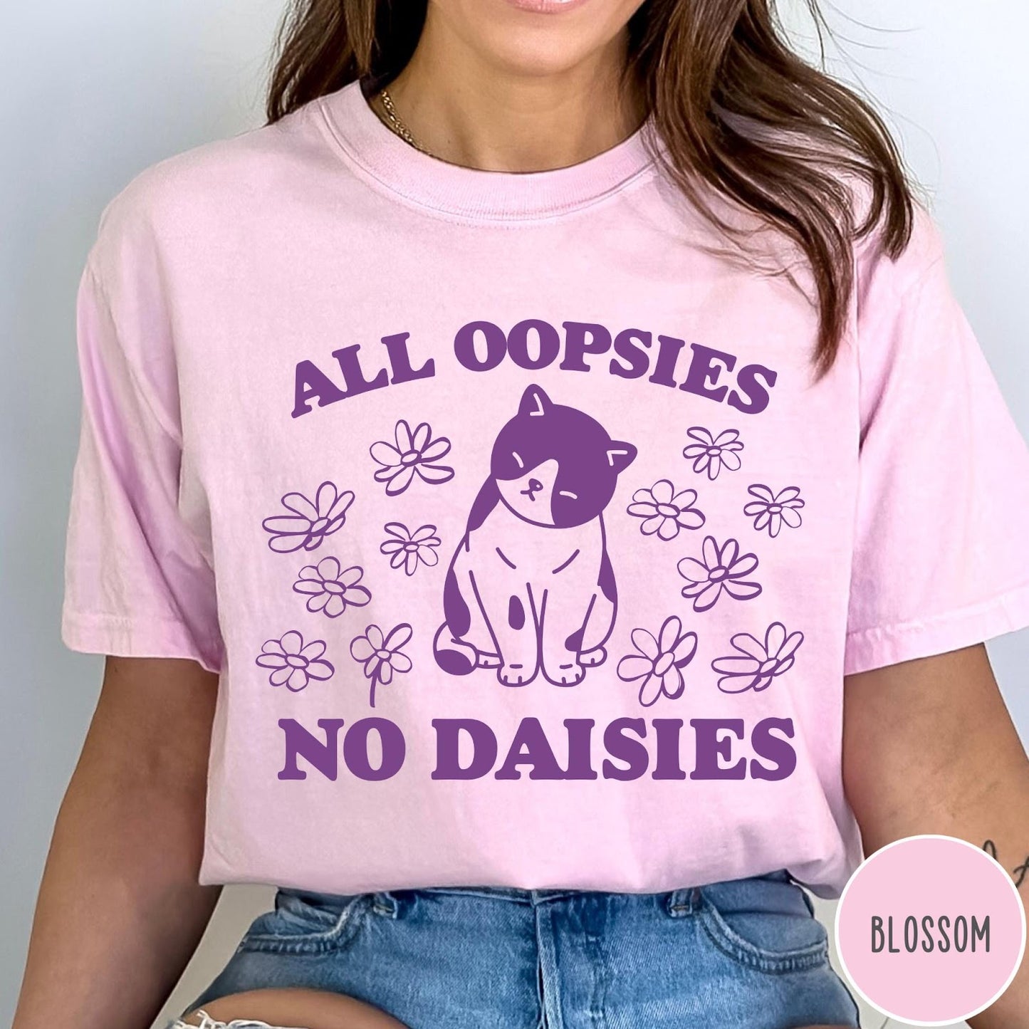Comfort Colors tee in Blossom featuring cat graphic with purple text reading All Oopsies No Daisies