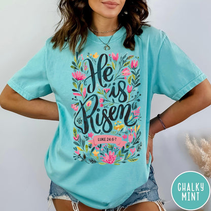 Comfort Colors tee in Chalky Mint featuring Easter religious floral graphic with He is Risen and Luke 24:6-7 text