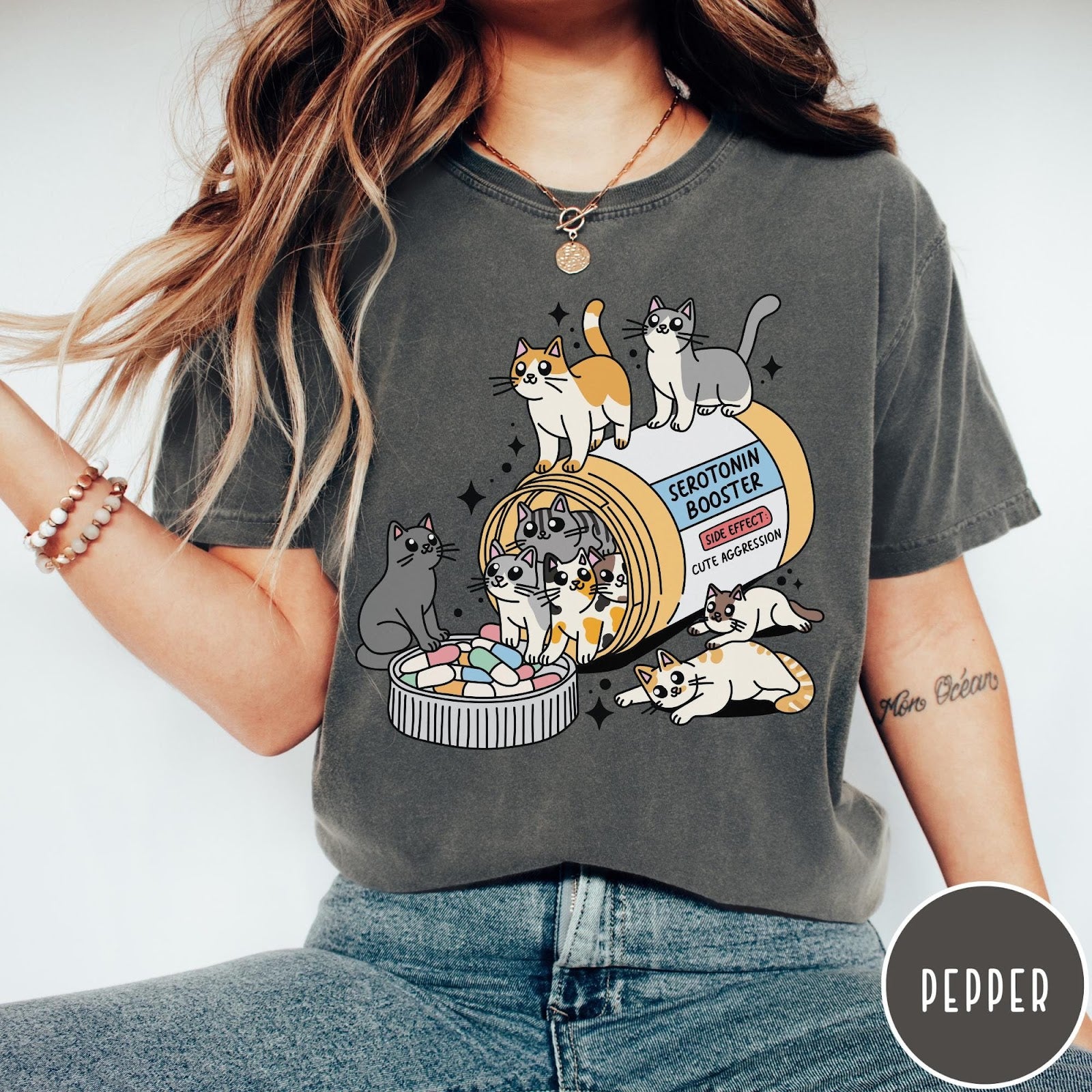 Comfort Colors tee in Pepper featuring graphic illustration of cats spilling out of a serotonin booster bottle