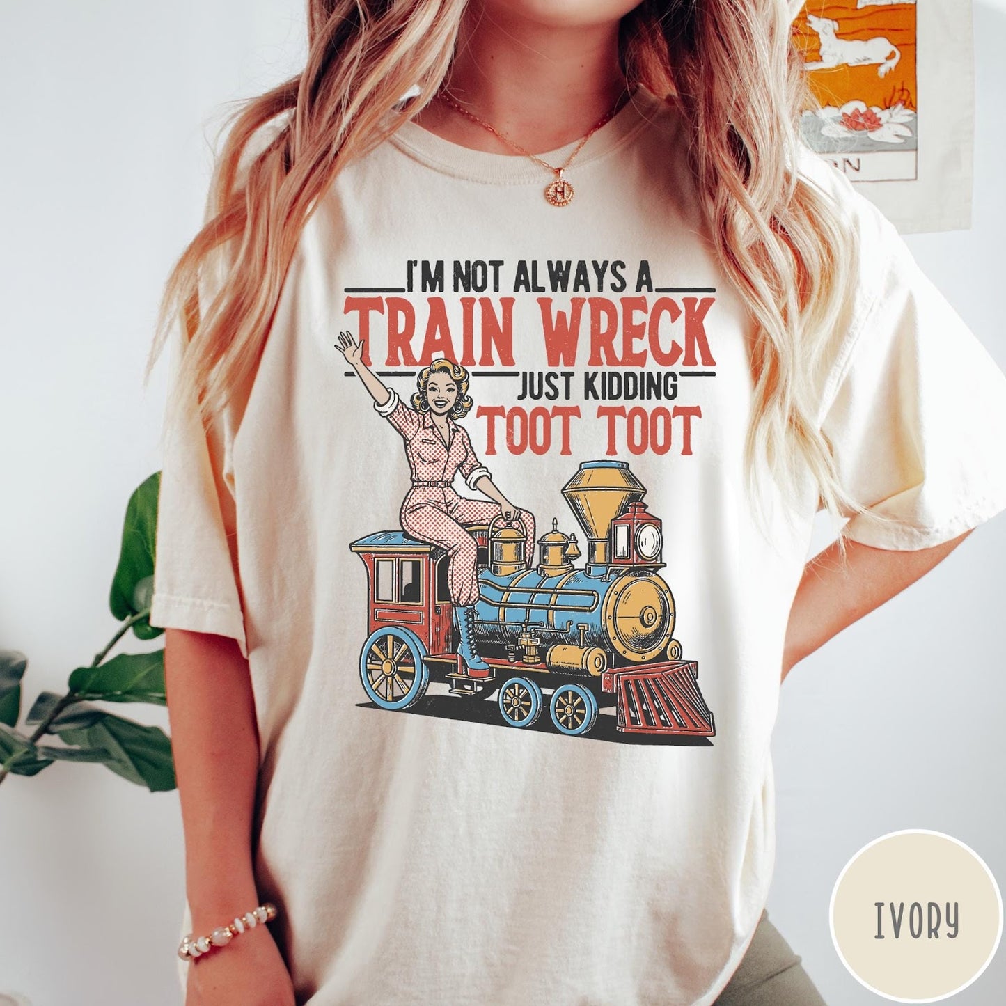 Comfort Colors tee in Ivory featuring vintage style pin-up woman sitting on a steam train graphic