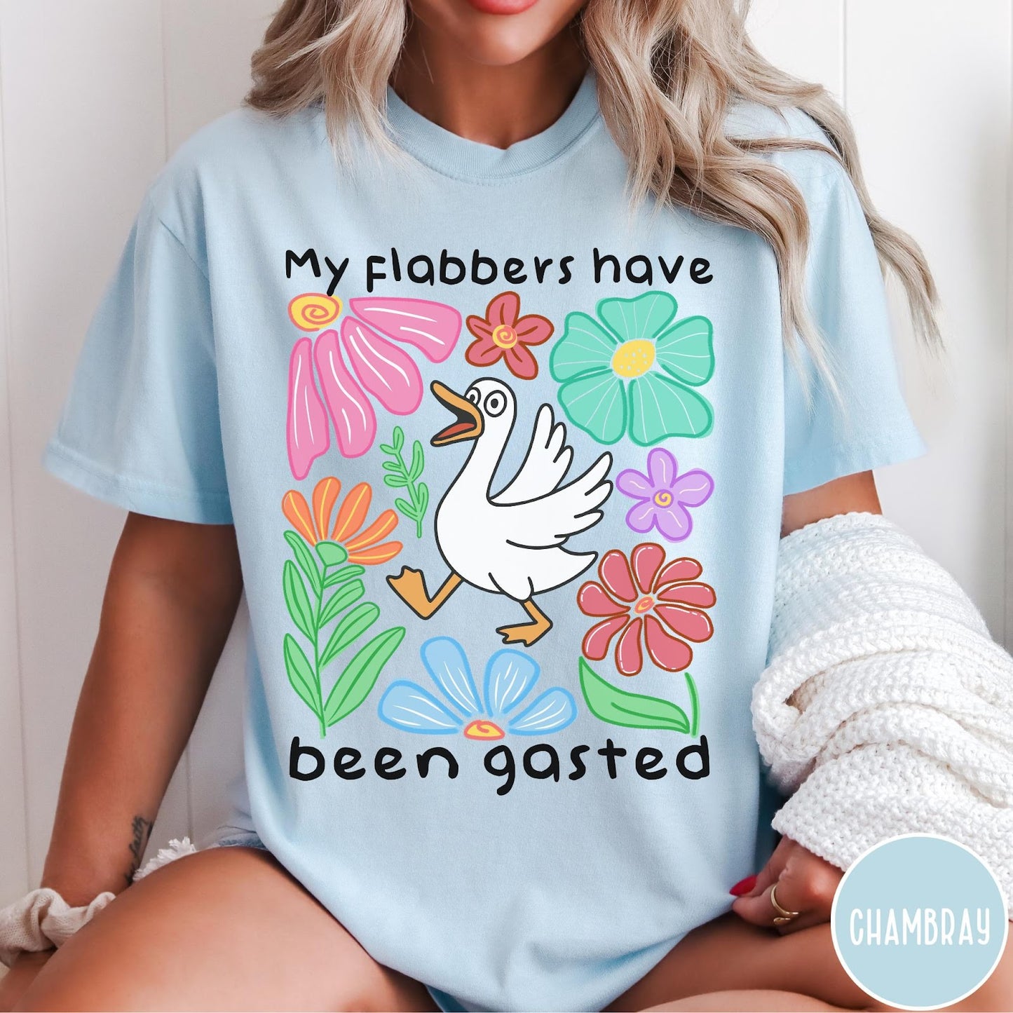 Comfort Colors tee in Chambray featuring playful cartoon style graphic of a goose surrounded by colorful flowers