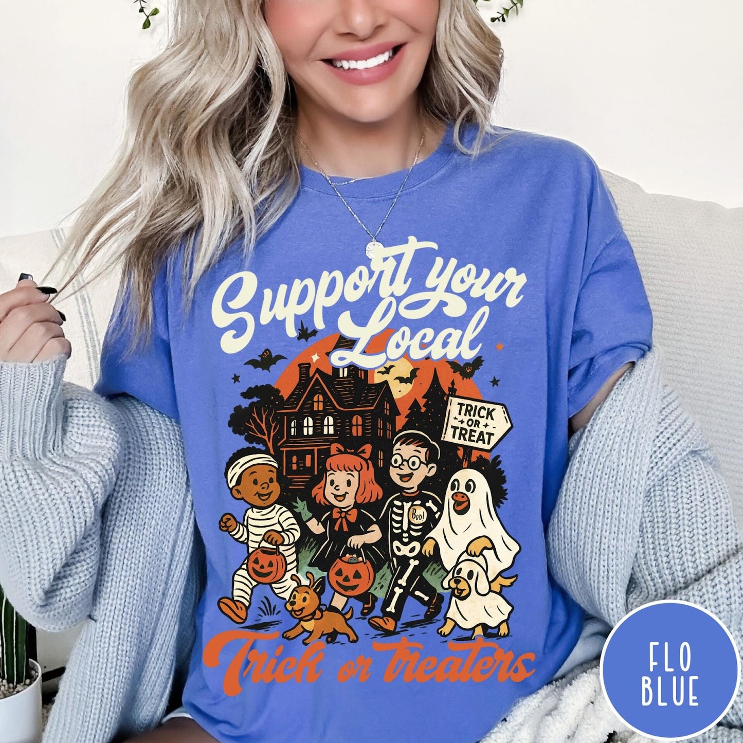 Comfort Colors tee in Flo Blue featuring vintage style trick or treaters graphic with a haunted house background