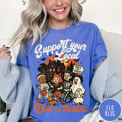 Comfort Colors tee in Flo Blue featuring vintage style trick or treaters graphic with a haunted house background
