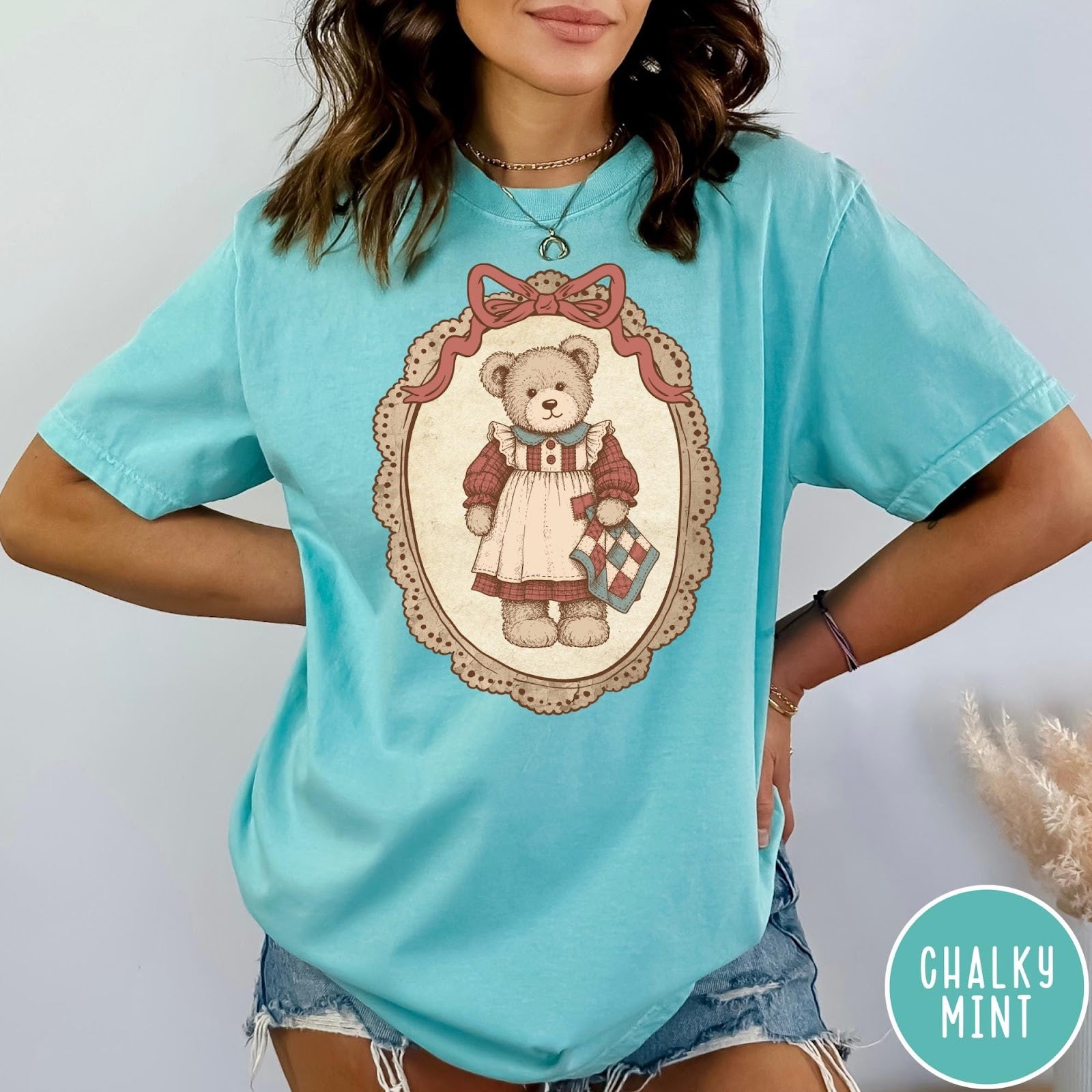 Comfort Colors tee in Chalky Mint featuring vintage style teddy bear graphic inside a decorative lace oval frame
