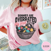 Comfort Colors tee in Blossom featuring graphic illustration of a raccoon sitting in an Easter basket