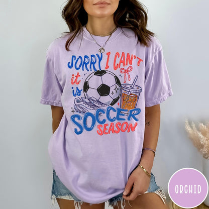 Comfort Colors tee in Orchid featuring screen print style soccer season graphic with ball and iced coffee
