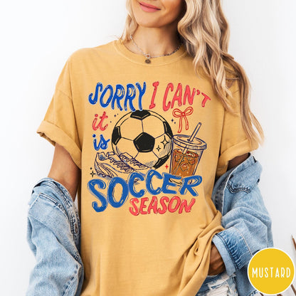 Comfort Colors tee in Mustard featuring screen print style soccer season graphic with ball and iced coffee