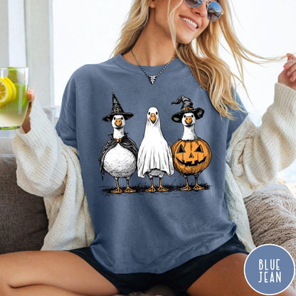 Comfort Colors tee in Blue Jean featuring Halloween graphic with three geese dressed as a witch, ghost, and pumpkin