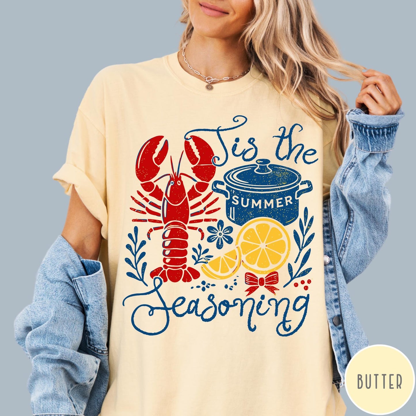 Comfort Colors tee in Butter featuring lobster boil graphic with a lobster, cooking pot, and lemon slices.