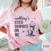 Comfort Colors tee in Blossom featuring illustrated style graphic of a small bear looking up at stars