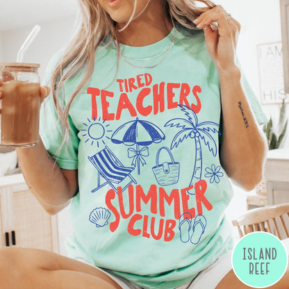 Comfort Colors tee in Island Reef featuring summer vacation graphic with beach umbrella, palm tree, and beach chair.