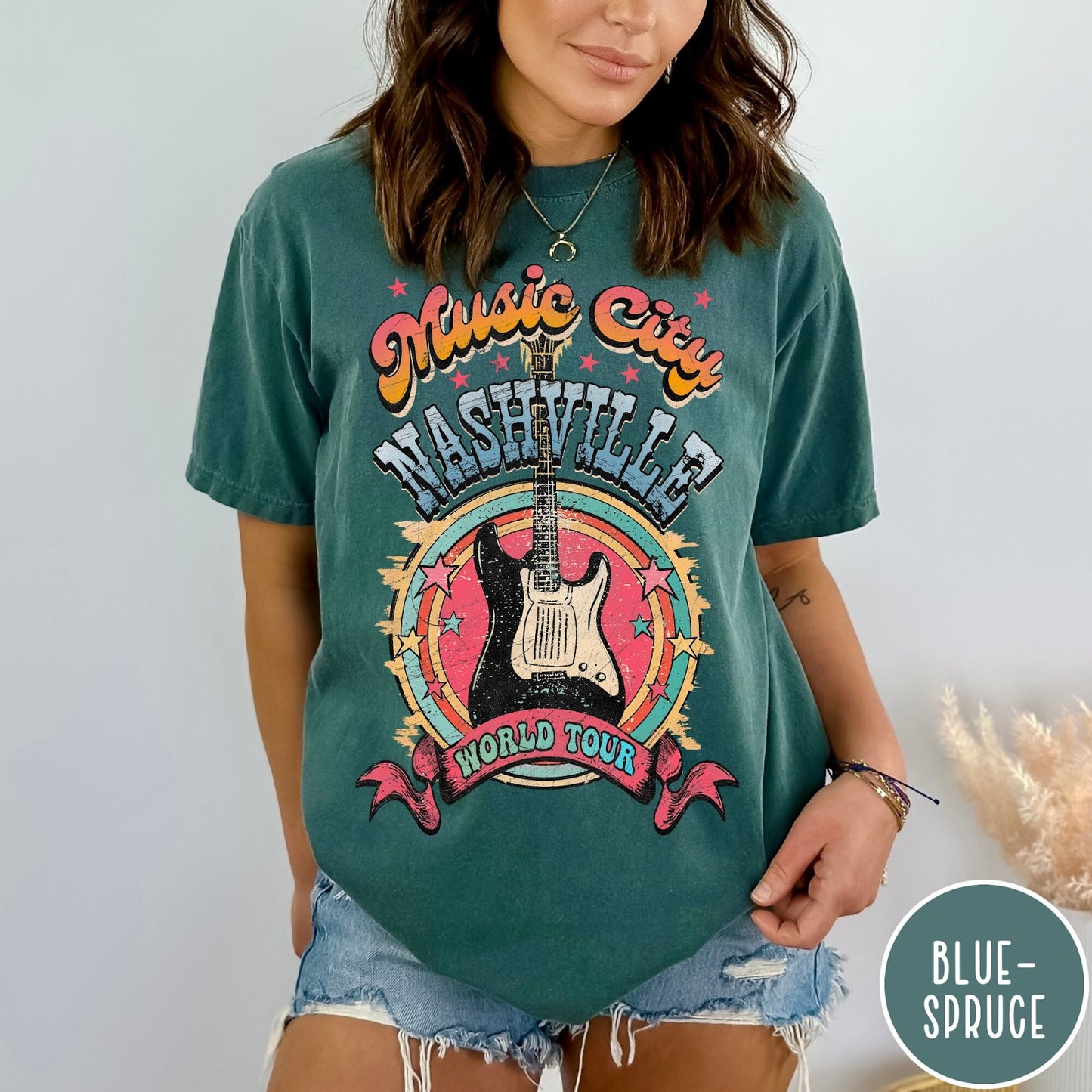 Comfort Colors tee in Blue Spruce featuring retro style Nashville Music City guitar graphic with colorful circular design