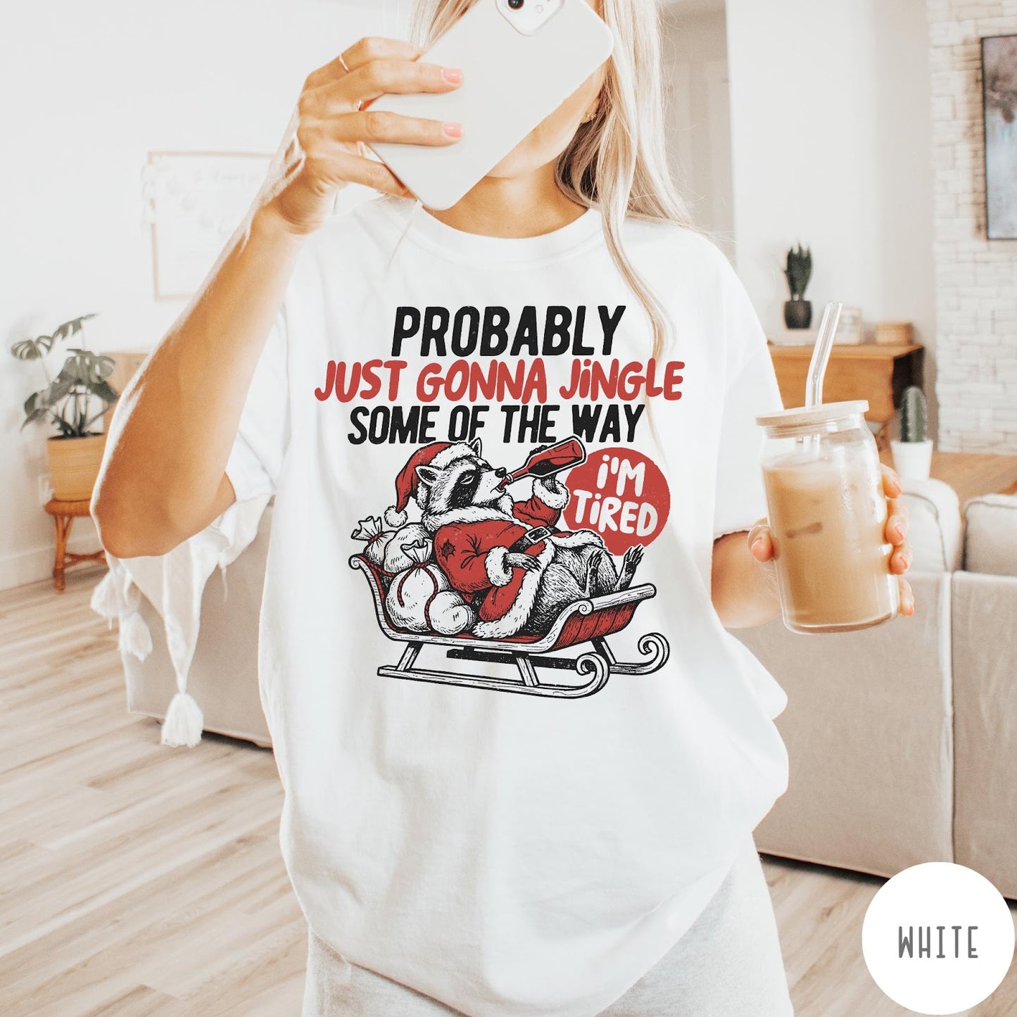 Comfort Colors tee in White featuring vintage style graphic of a tired raccoon in a Santa sleigh