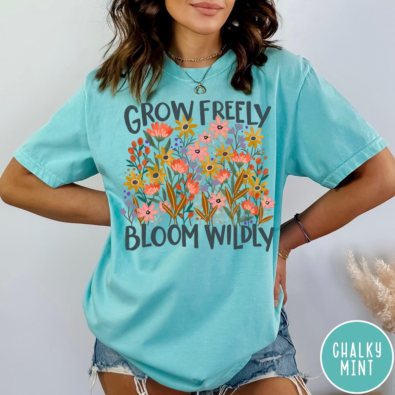 Comfort Colors tee in Chalky Mint featuring wildflower design with text Grow Freely Bloom Wildly in earthy tones