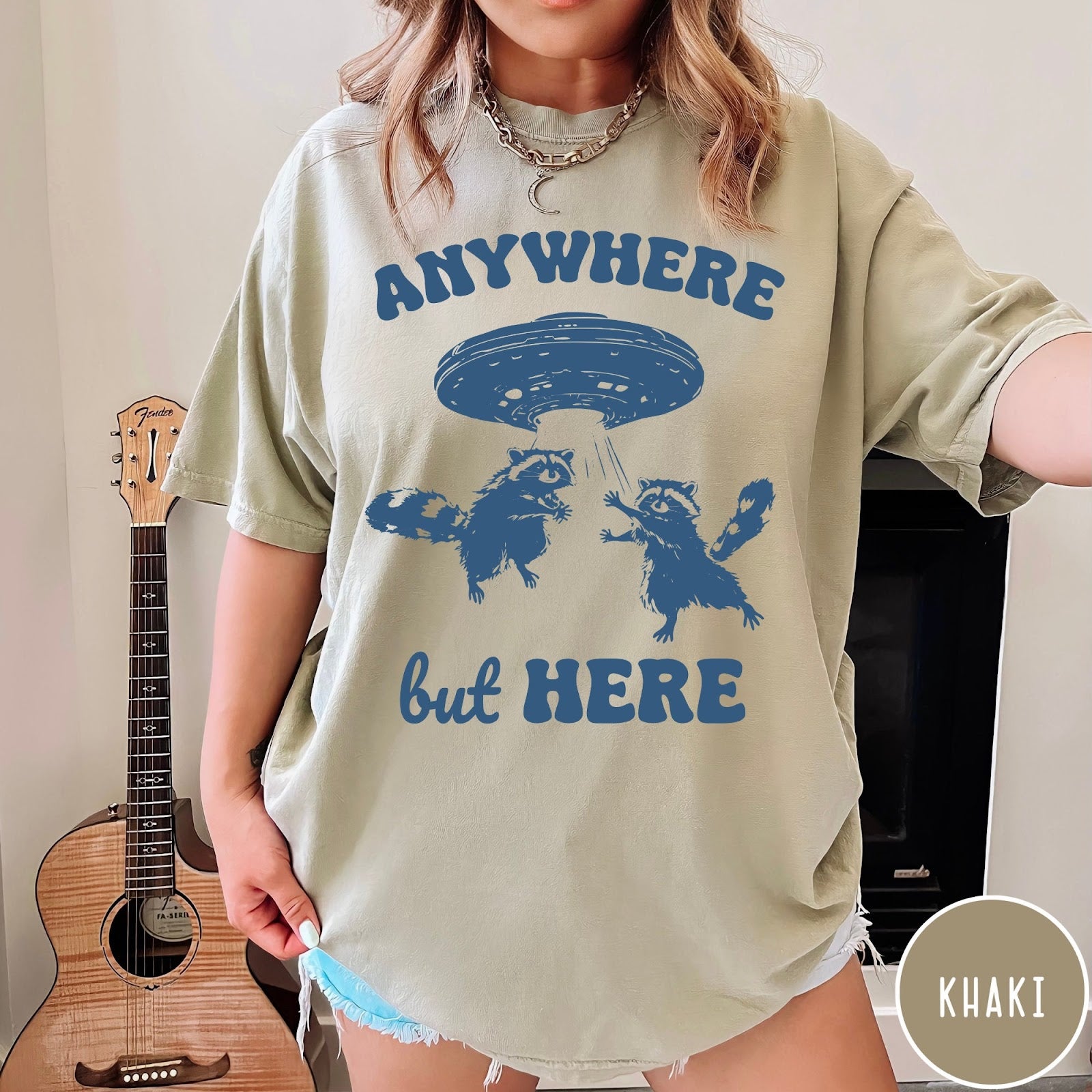 Comfort Colors tee in Khaki featuring whimsical graphic style with two raccoons being abducted by a UFO