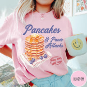 Comfort Colors tee in Blossom featuring watercolor style graphic of a stack of pancakes with blueberries and syrup