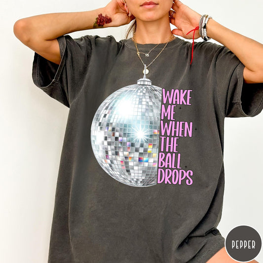Comfort Colors tee in Pepper featuring disco ball graphic with text Wake Me When The Ball Drops